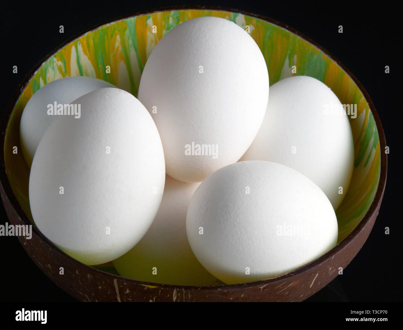 Fresh eggs on the black background Stock Photo - Alamy