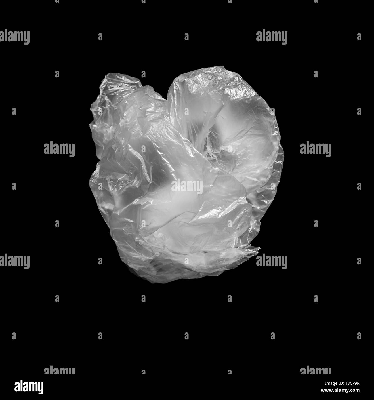 Crumpled plastic bag on a black background. Environmental pollution