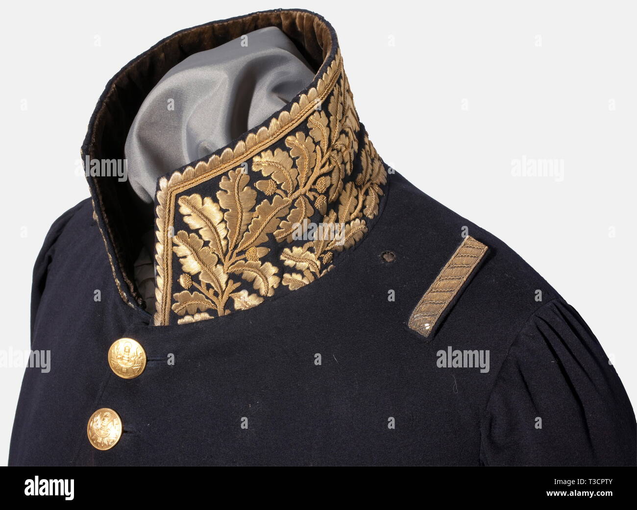 A coat for a brigadier general (1814), period of the First Restoration Fine blue cloth, the collar and cuffs are richly embroidered with golden oak leaves (braided embroidery), the coattails bear embroidered grenades and winged staffs with lightning bolts. Gold embroidered loops sewn on the shoulders for the epaulettes. All of the gilded buttons for a general officer are present. The inside of the collar lined with black velvet. The lower hem trimmed with leather. Bright colour, well preserved, a few small moth holes. This uniform differs from un, Additional-Rights-Clearance-Info-Not-Available Stock Photo