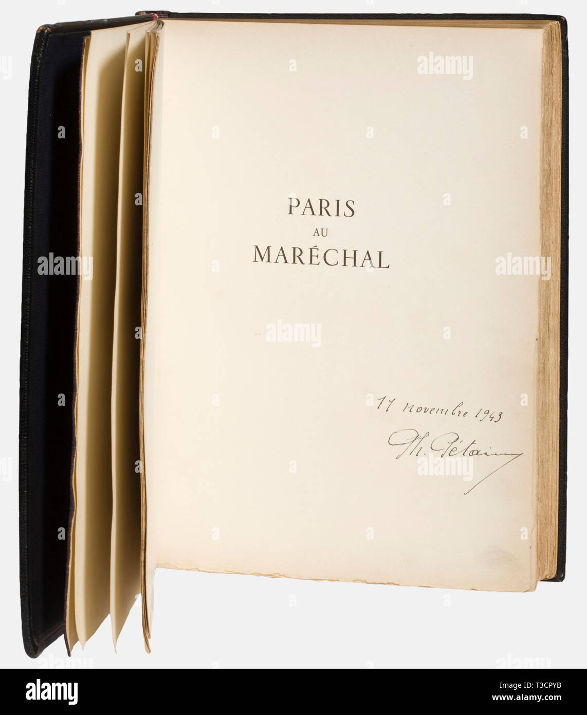 Marshal Philippe Pétain (1856 - 1951), a presentation book from the City of Paris 'Paris au Maréchal' A personal gift from Pétain as Head of State to the Argentine Ambassador to Vichy, Ricardo Olivera in 1943. Large format, 153 pages, numerous plates with engravings, among others by Jacquemin and Cottert, and biographical descriptions of the Marshal's postings in Paris. Dark blue binding of Morocco leather stamped with gold monogram 'PP' and the Francisca. The gift inscription to the ambassador dated '25 Mai 1943' stamped in gold on the inside of the dust, No-Exclusive-Use | Editorial-Use-Only Stock Photo