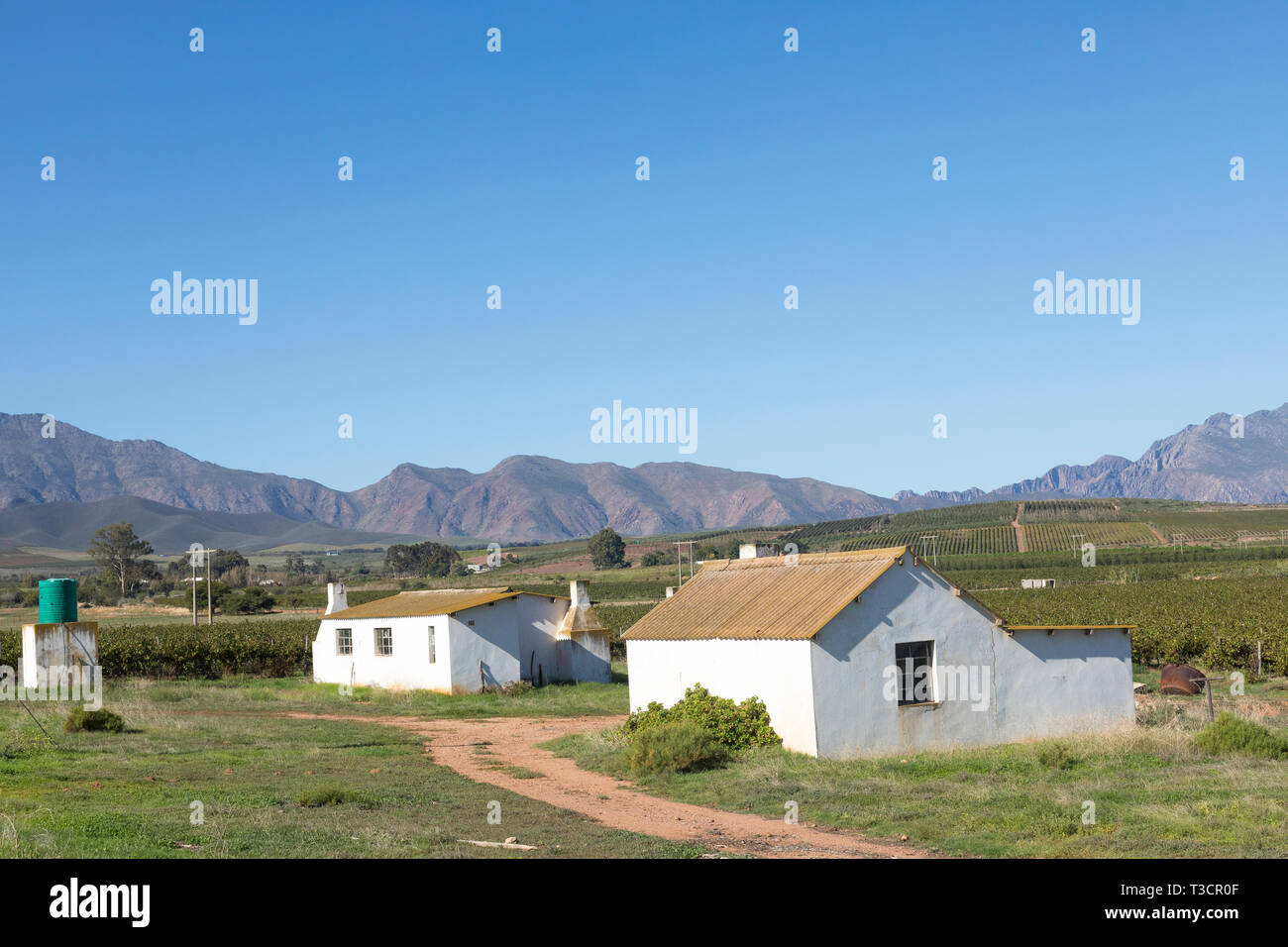 Farm workers cottages  with outdoor ablutions in the Robertson Wine Valley with Langeberg Mountains, Klaasvoogds, Western Cape Winelands, South Africa Stock Photo