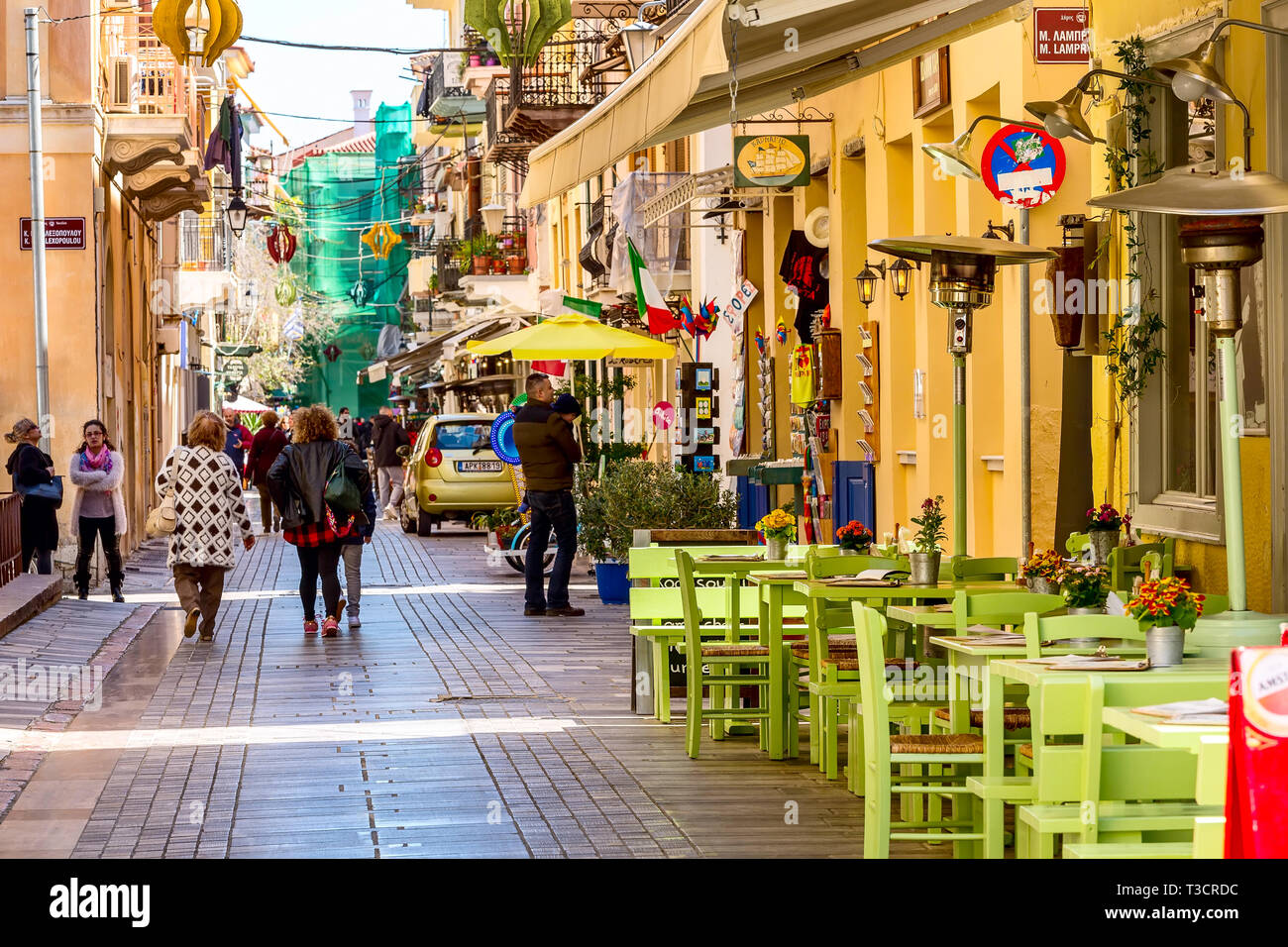 Nafplio, Greece - March 30, 2019: Old town street panorama with restaurants in Nafplion, Peloponnese Stock Photo