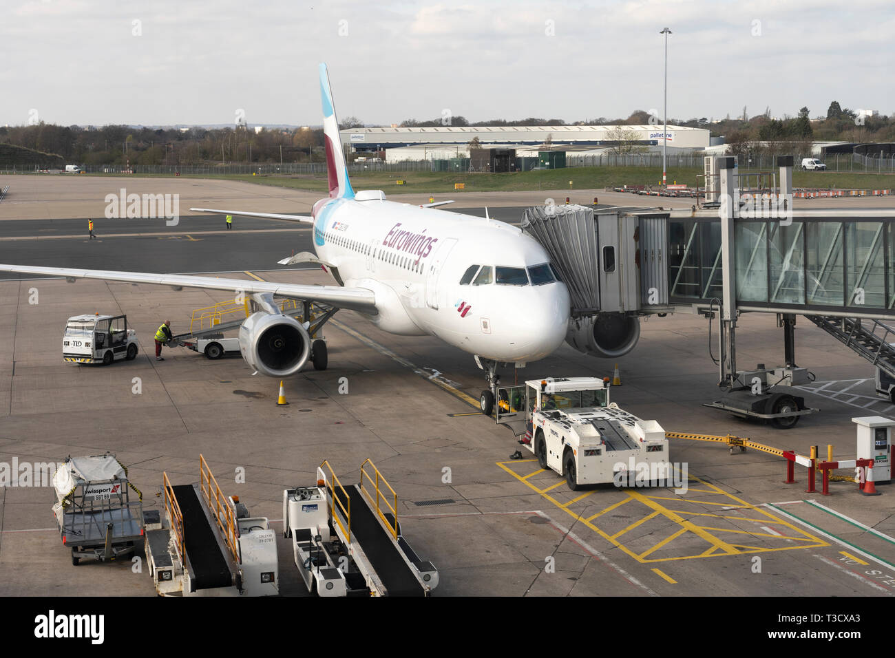 A Eurowings Airbus A319 docked at an air bridge at Birmingham International Airport, England Stock Photo