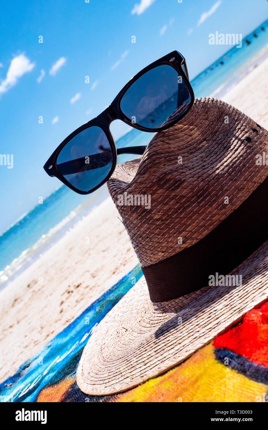 Straw hat, bag, sun glasses and flip flops on a tropical beach Stock ...