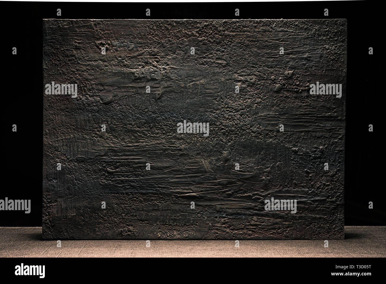 Grungy dark stucco wall with spotlight, background photo texture Stock Photo