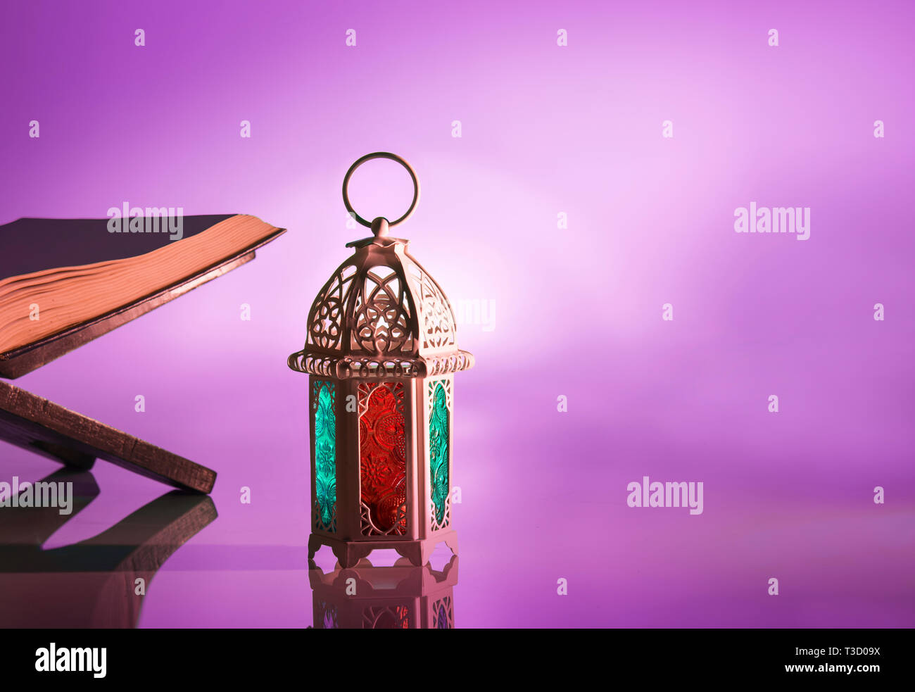 Arabic lamp with beautiful light and holy koran. Islamic concept image