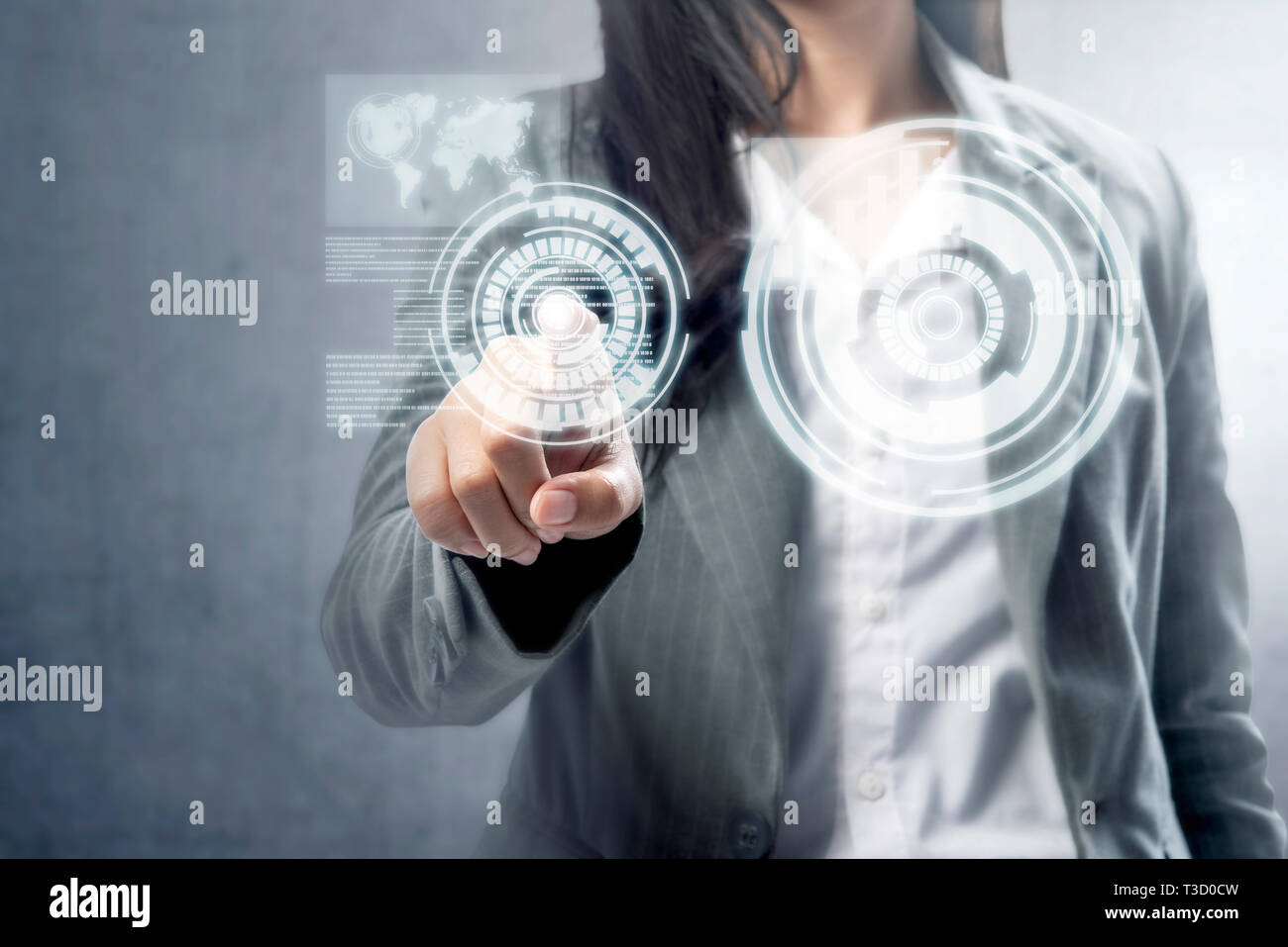 Business woman touch a circle on virtual screen which display the interface of world map and binary code. Digital technology concept Stock Photo