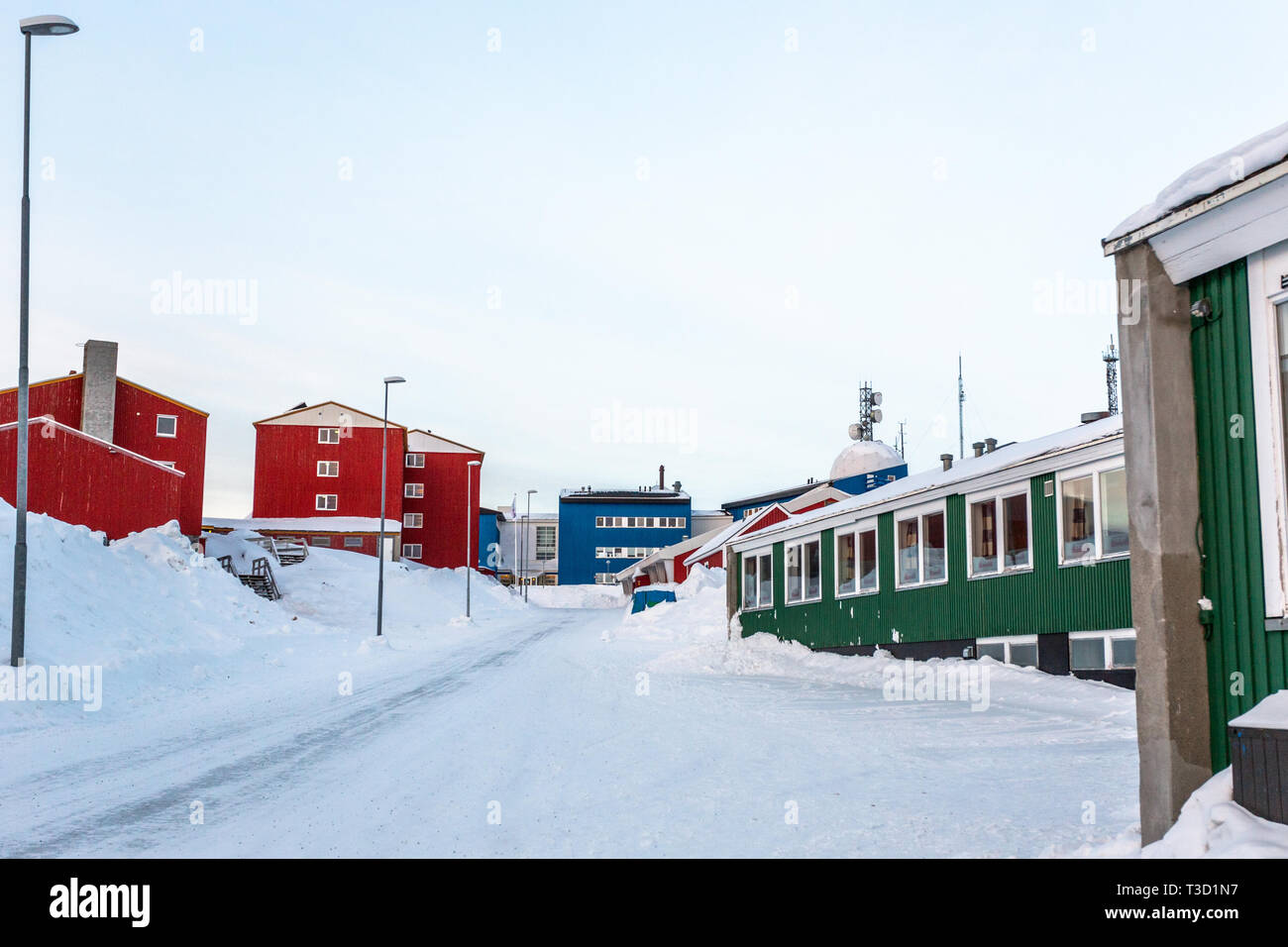 Greenlandic street covered in snow with colorful buildings, Nuuk city center, Greenland Stock Photo