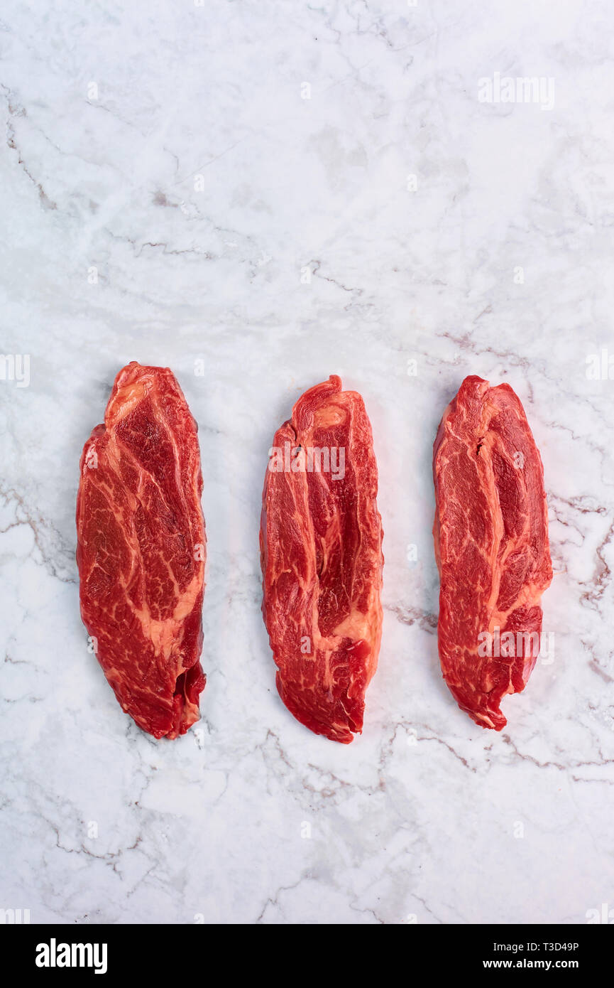 Raw Marbled Beef Steaks At White Marble Background Copy Space Vertical Stock Photo Alamy