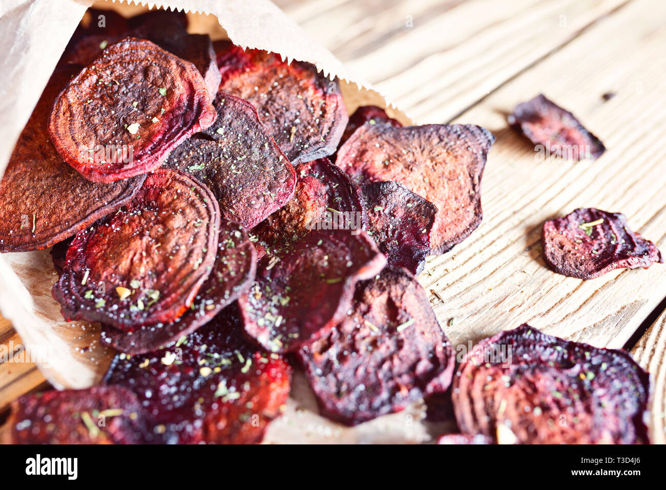 Crispy beet chips with sea salt in paper packaging Stock Photo