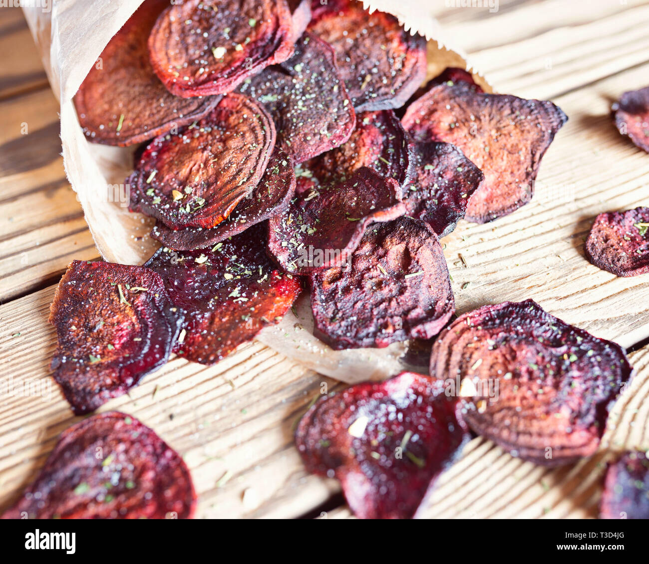 Crispy beet chips with sea salt in paper packaging Stock Photo