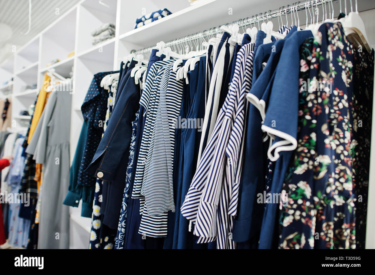 Female blue colorful clothing set of on the racks in clothing store brand  new modern boutique Stock Photo - Alamy