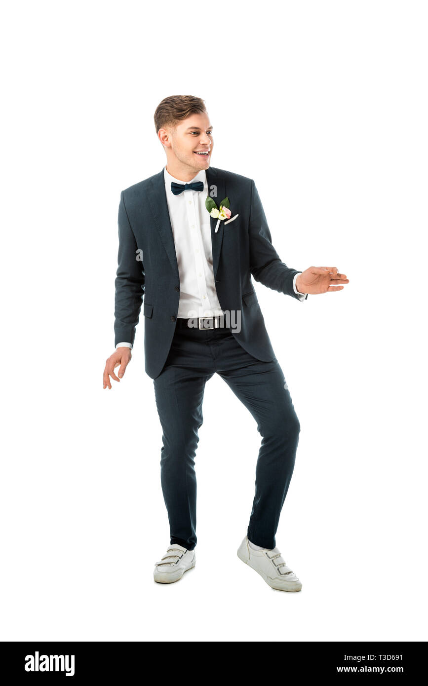 cheerful groom dancing in black elegant suit and white sneakers isolated on  white Stock Photo - Alamy