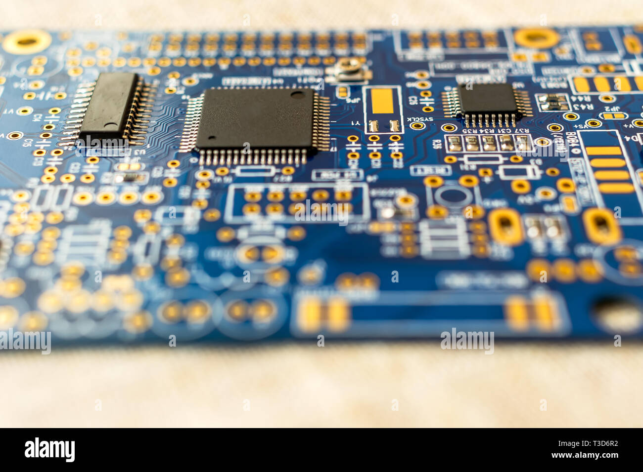 Circuitboard with resistors microchips and smd electronic components - selective focus Stock Photo