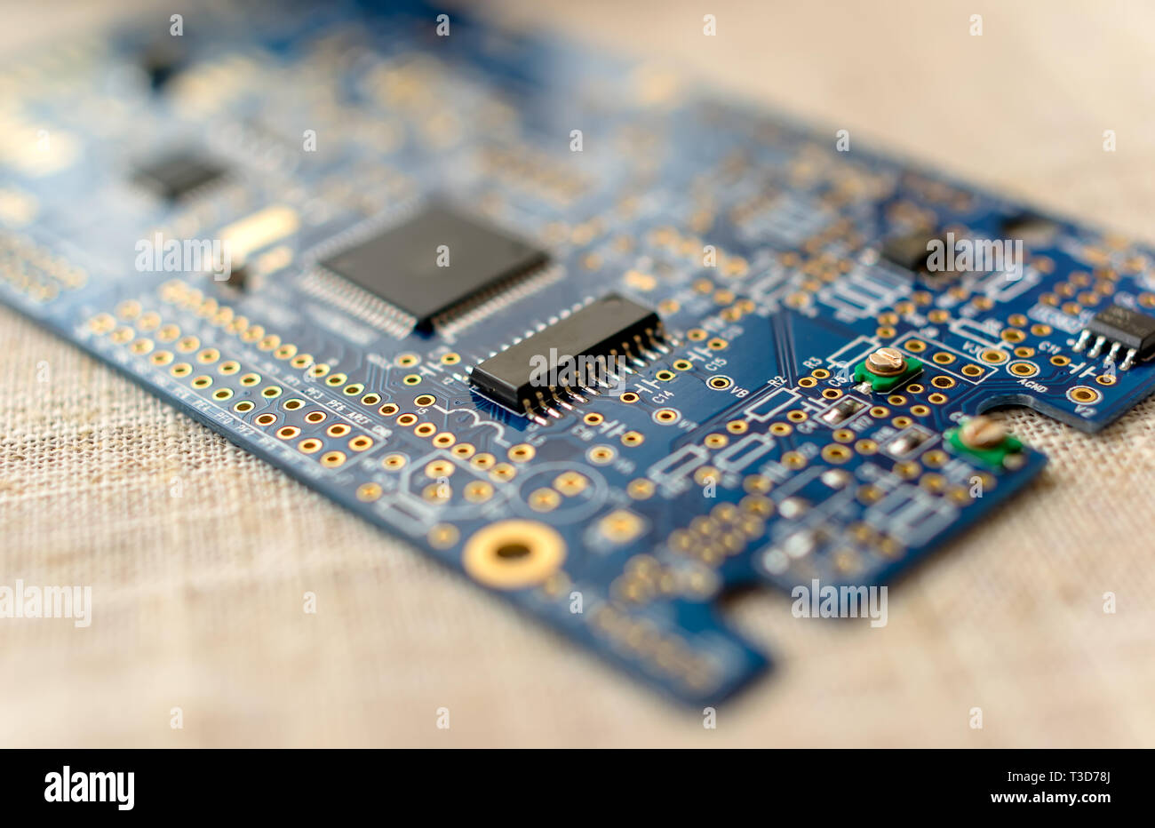 Circuitboard with resistors microchips and smd electronic components - selective focus Stock Photo