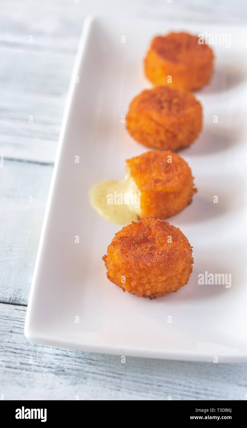 Camembert nuggets on the white plate Stock Photo