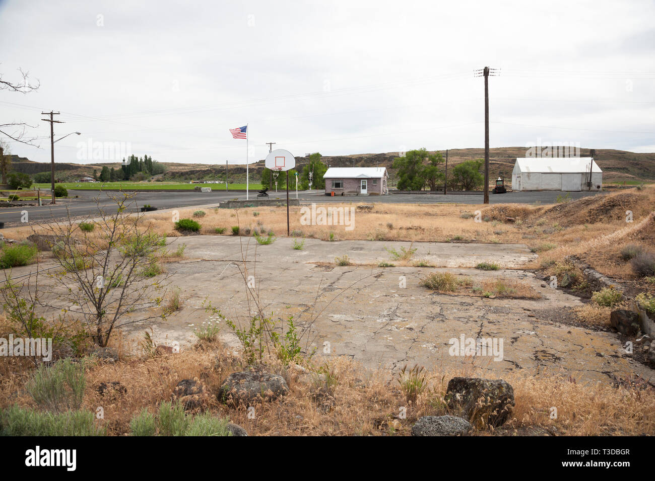 Abandoned basketball court in a rural American small town. Economic decline in poor areas of the United States. Stock Photo