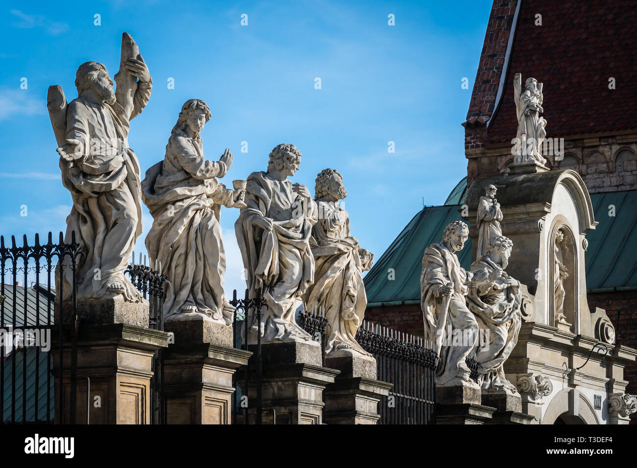 Krakow, Poland - March 22, 2019 - statues in front of The Church of Saints Peter and Paul Stock Photo