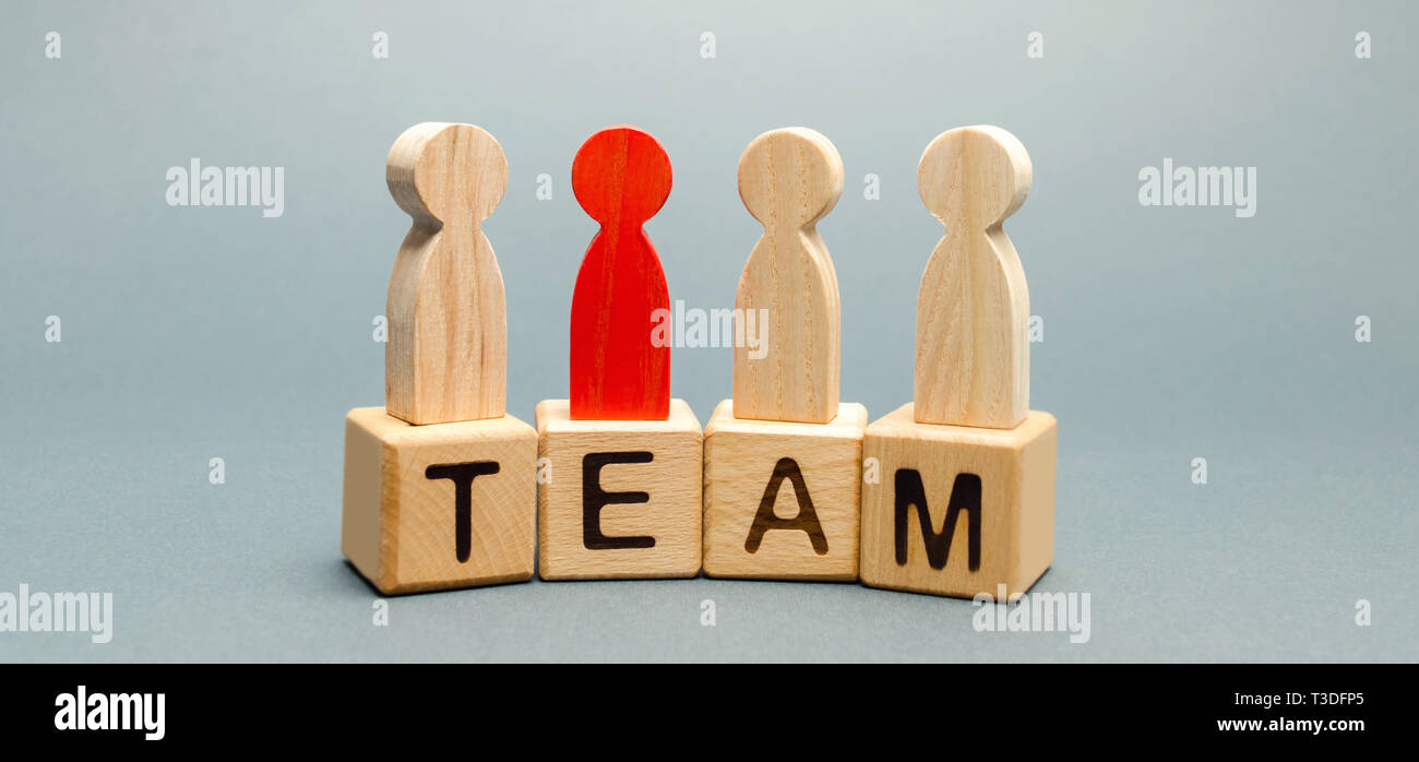 Wooden blocks with the word Team and a crowd of workers with a leader