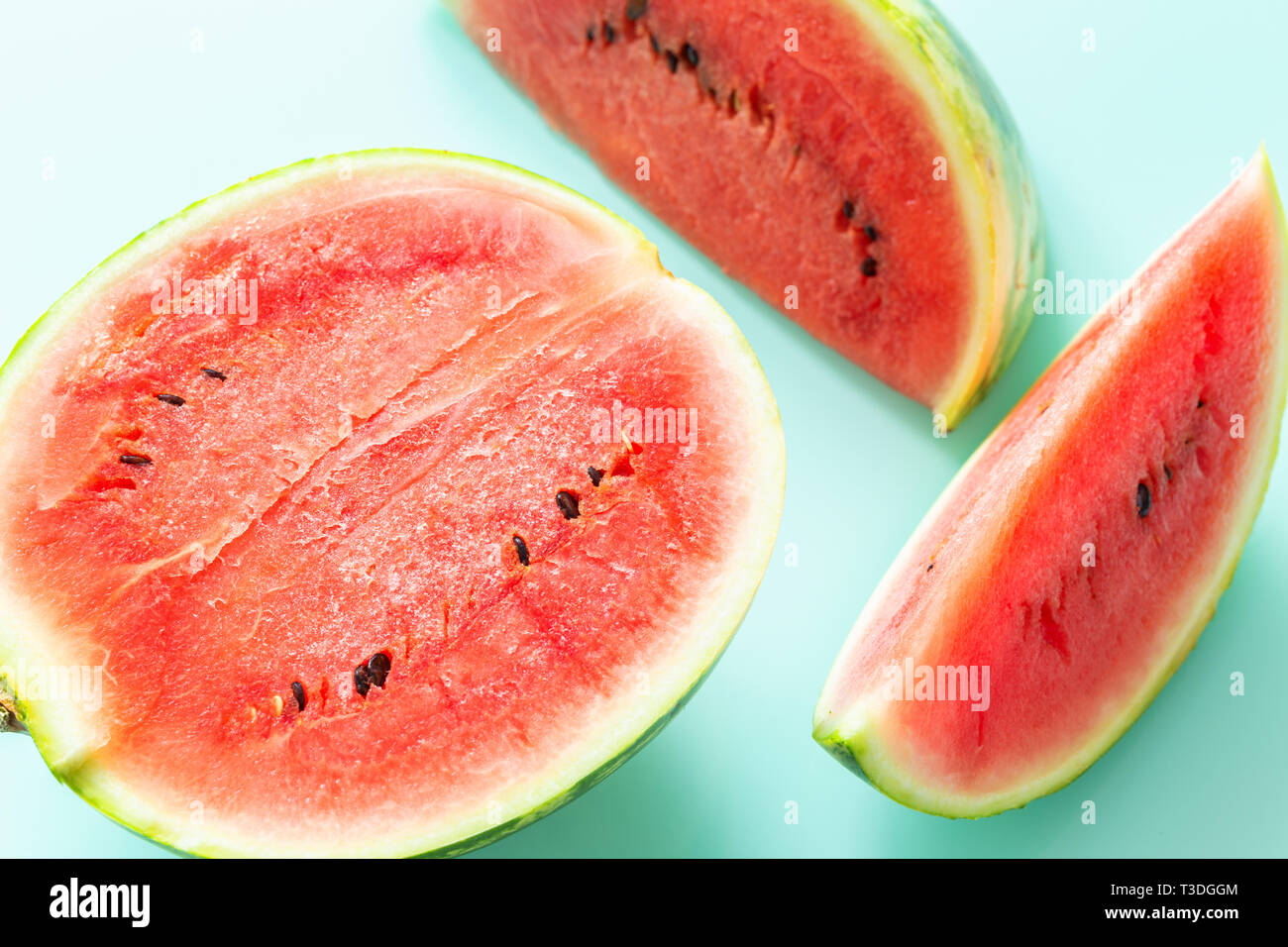 pieces of juicy watermelon on a pastel blue background Stock Photo - Alamy
