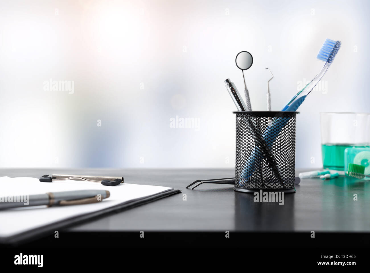 Black Office Desk Of A Dentist With Office And Dental Supplies
