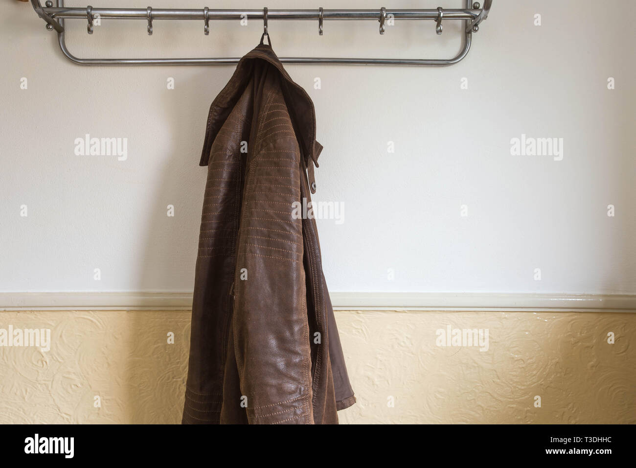 Coats hanging wall hi-res stock photography and images - Alamy