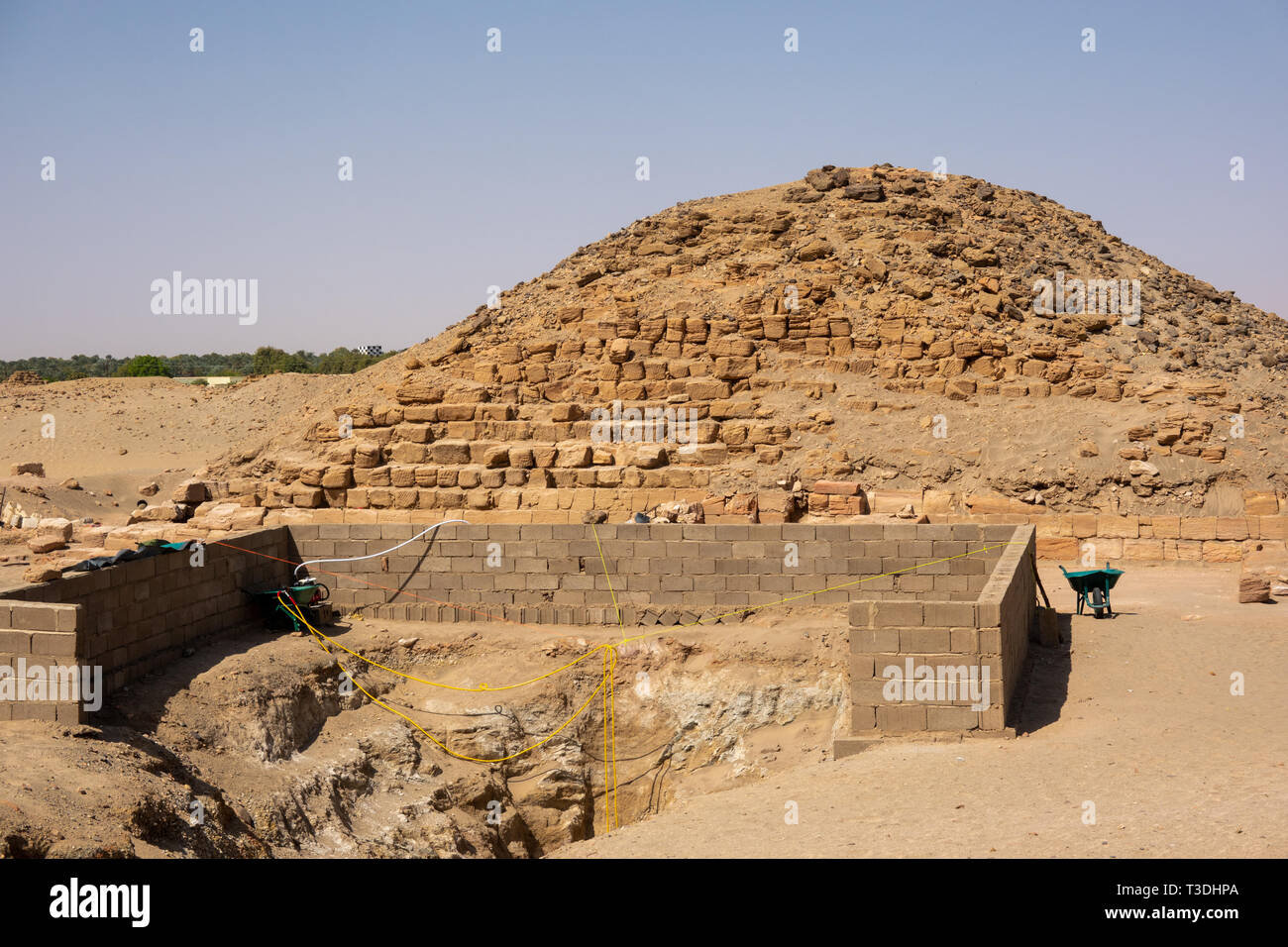 Nuri, Sudan, February 9., 2019: Temporary retaining wall in front of the Access via a staircase to the underground entrance of a pyramid of black phar Stock Photo