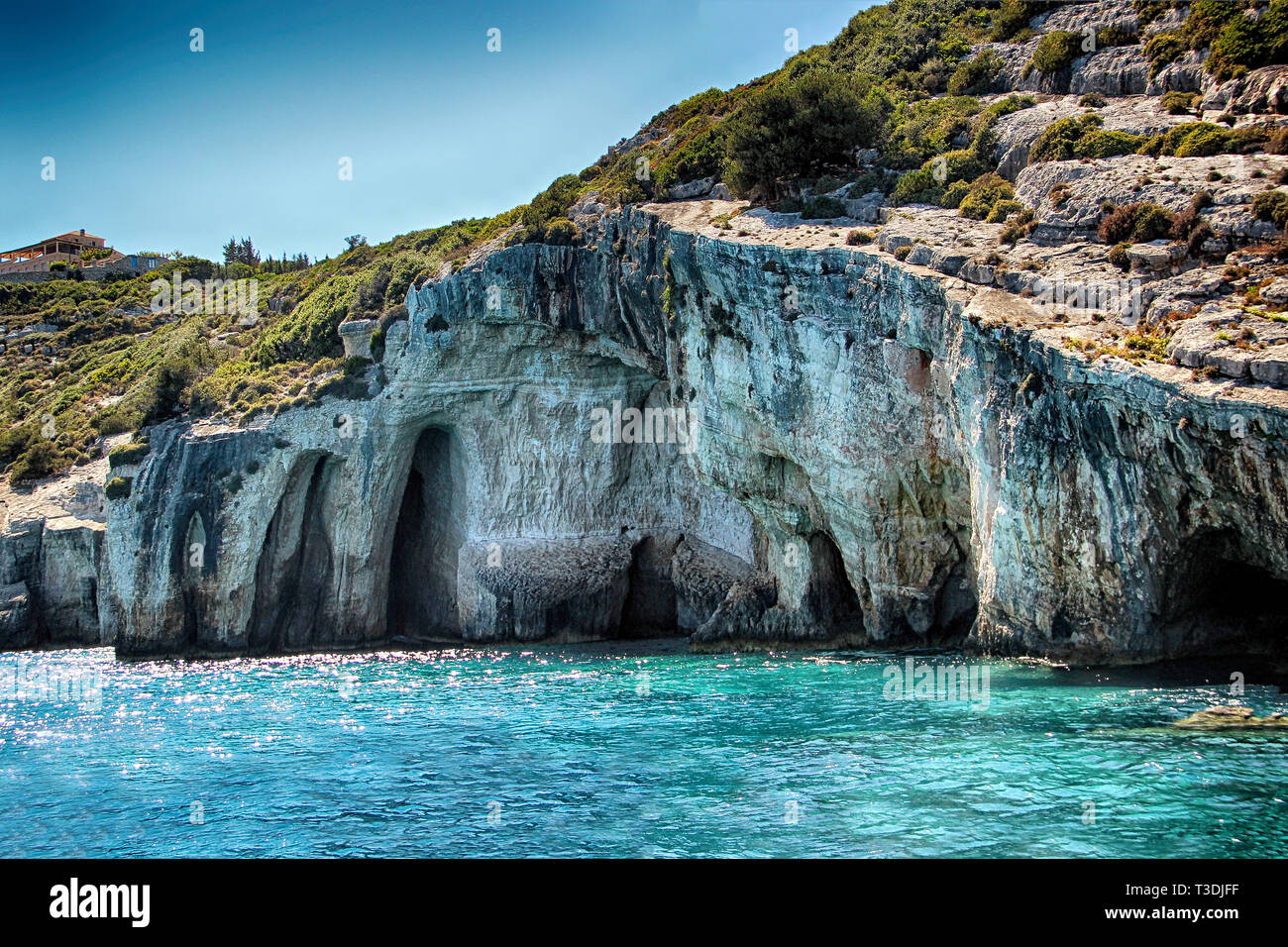 Blue caves on the sea in Zakynthos in Greece. Clear water of medditerian sea in sunny day at summer. Stock Photo