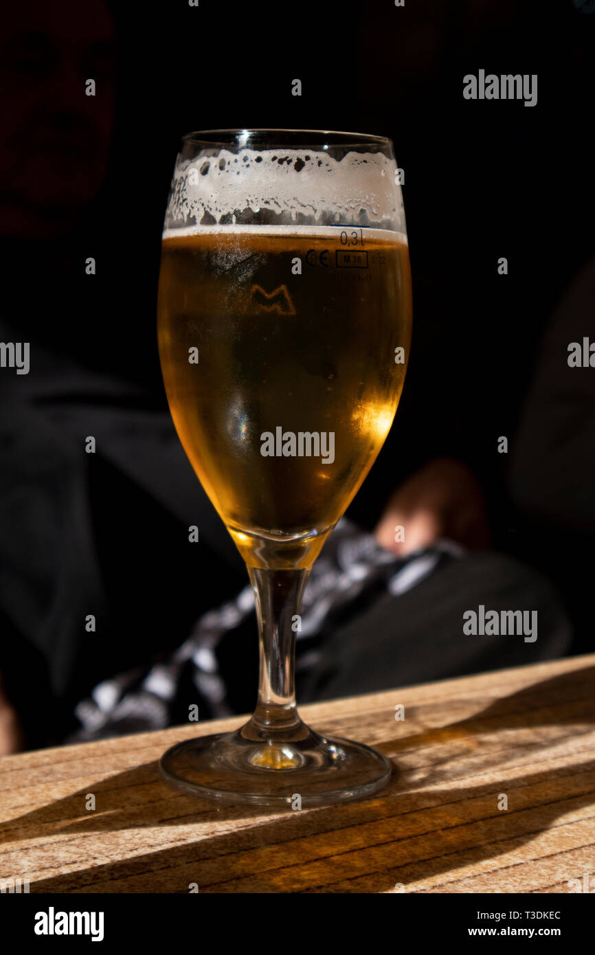 Beer glass at the wood  table close-up, black background . Stock Photo