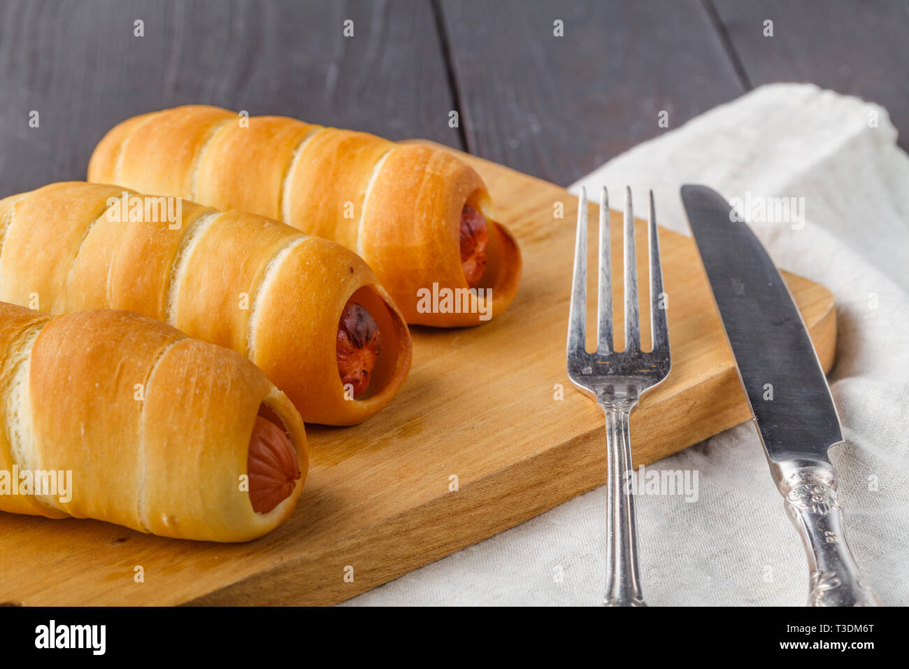 Home made pigs in a blanket. Sausages rolled in croissant dough, baked Stock Photo