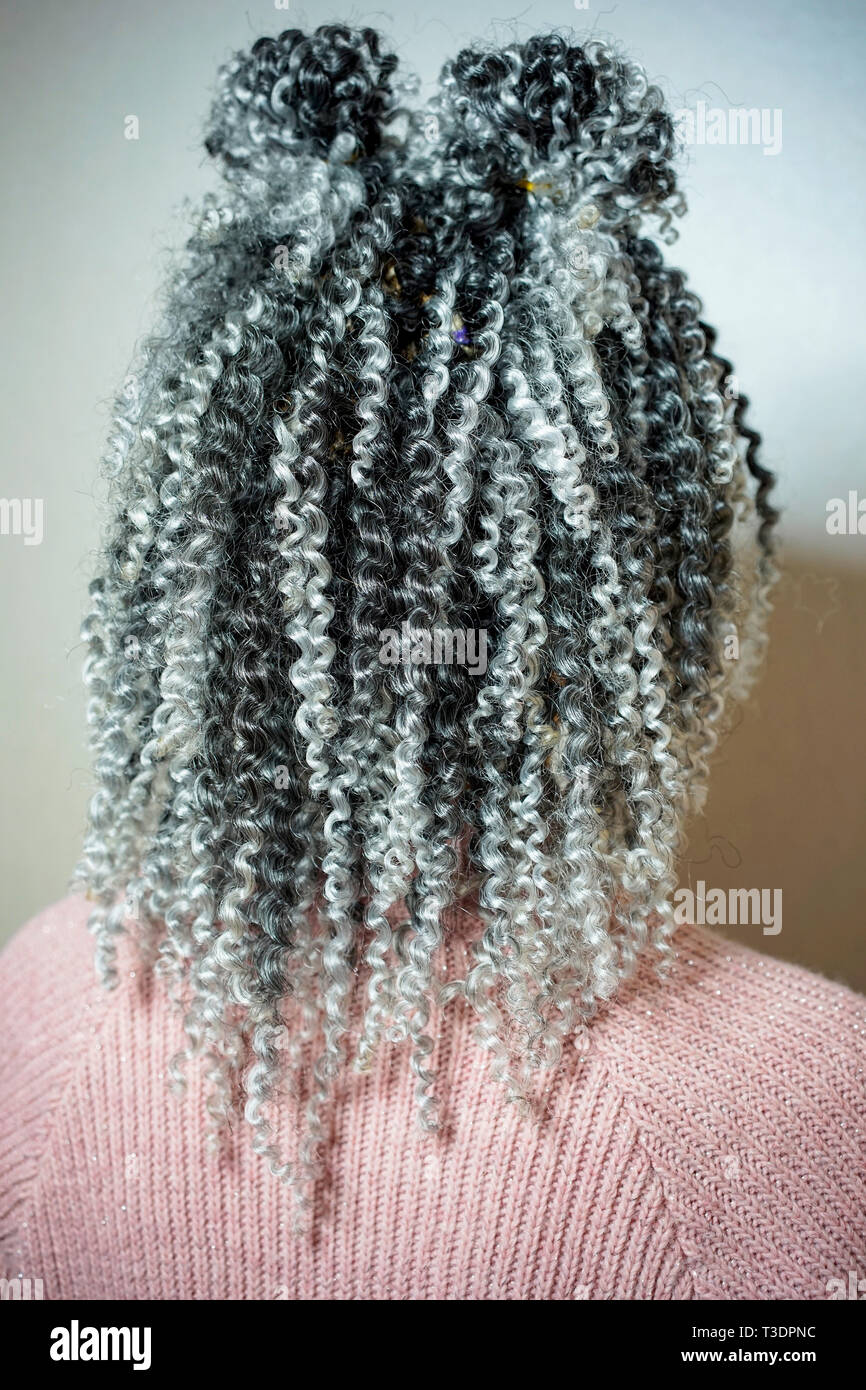 cornrows women curls beautiful Kanekalon curls woven into the hair with a hook, African-style hairstyle with artificial hair Stock Photo