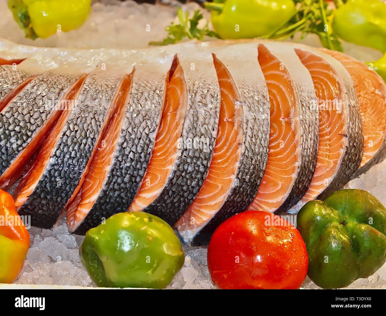 Raw salmon on ice at a fish market with vegetables Stock Photo - Alamy