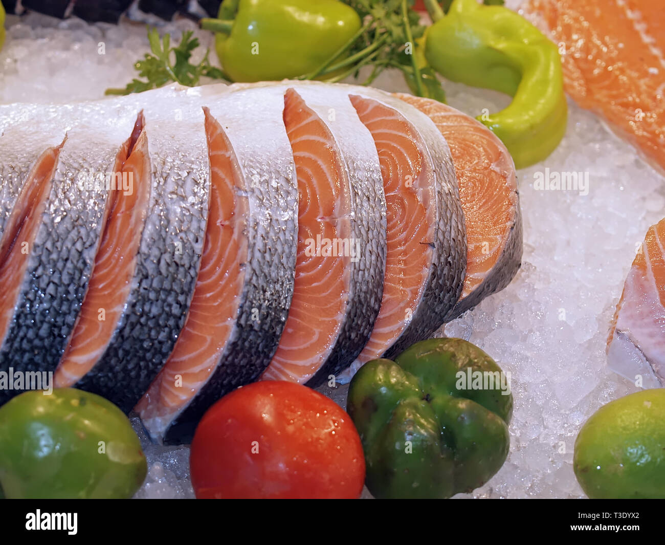Raw salmon on ice at a fish market with vegetables Stock Photo - Alamy