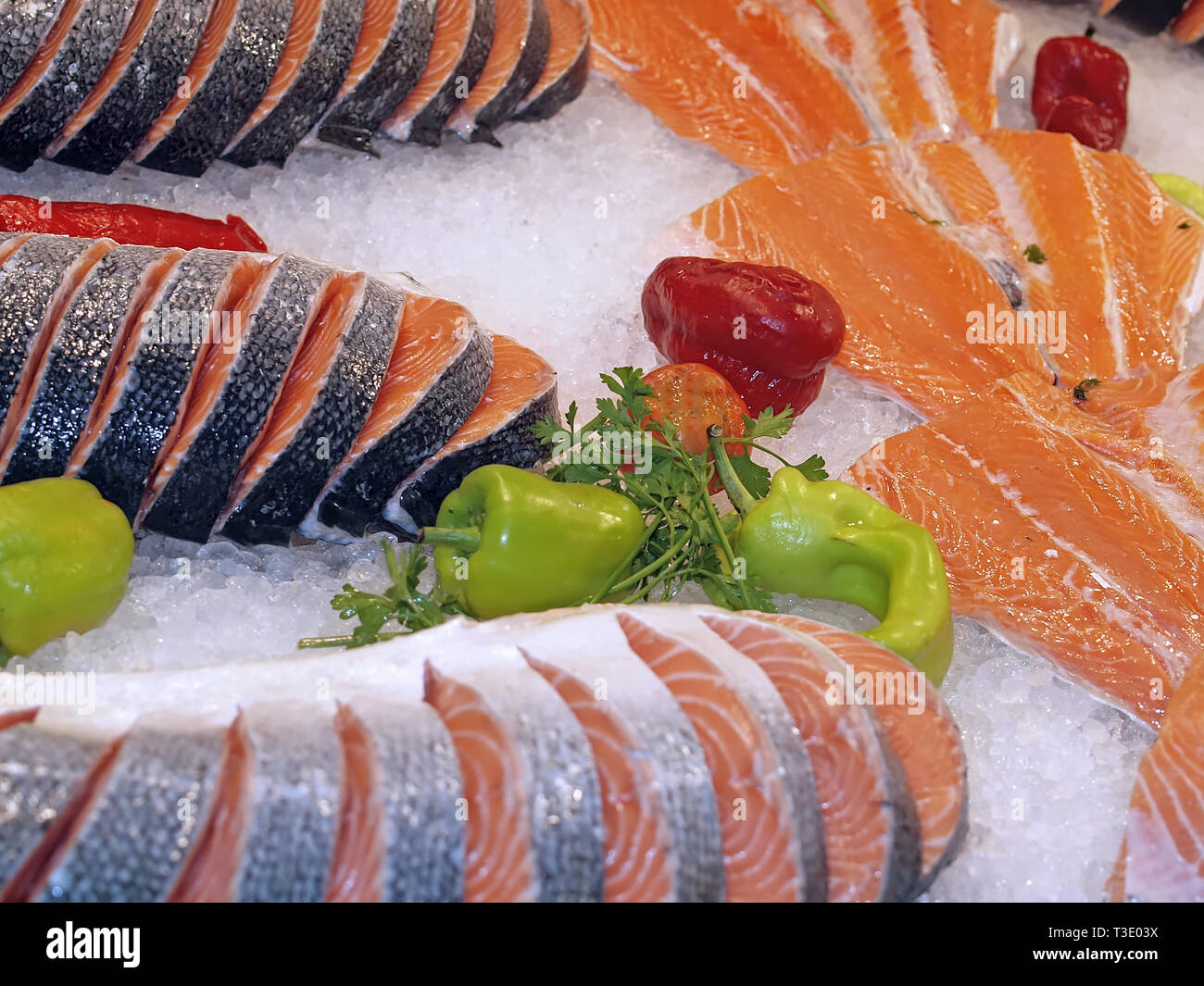 Raw salmon on ice at a fish market with vegetables Stock Photo - Alamy