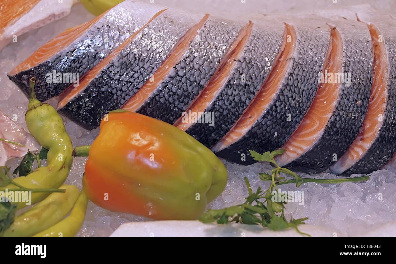 Raw salmon on ice at a fish market with vegetables Stock Photo - Alamy