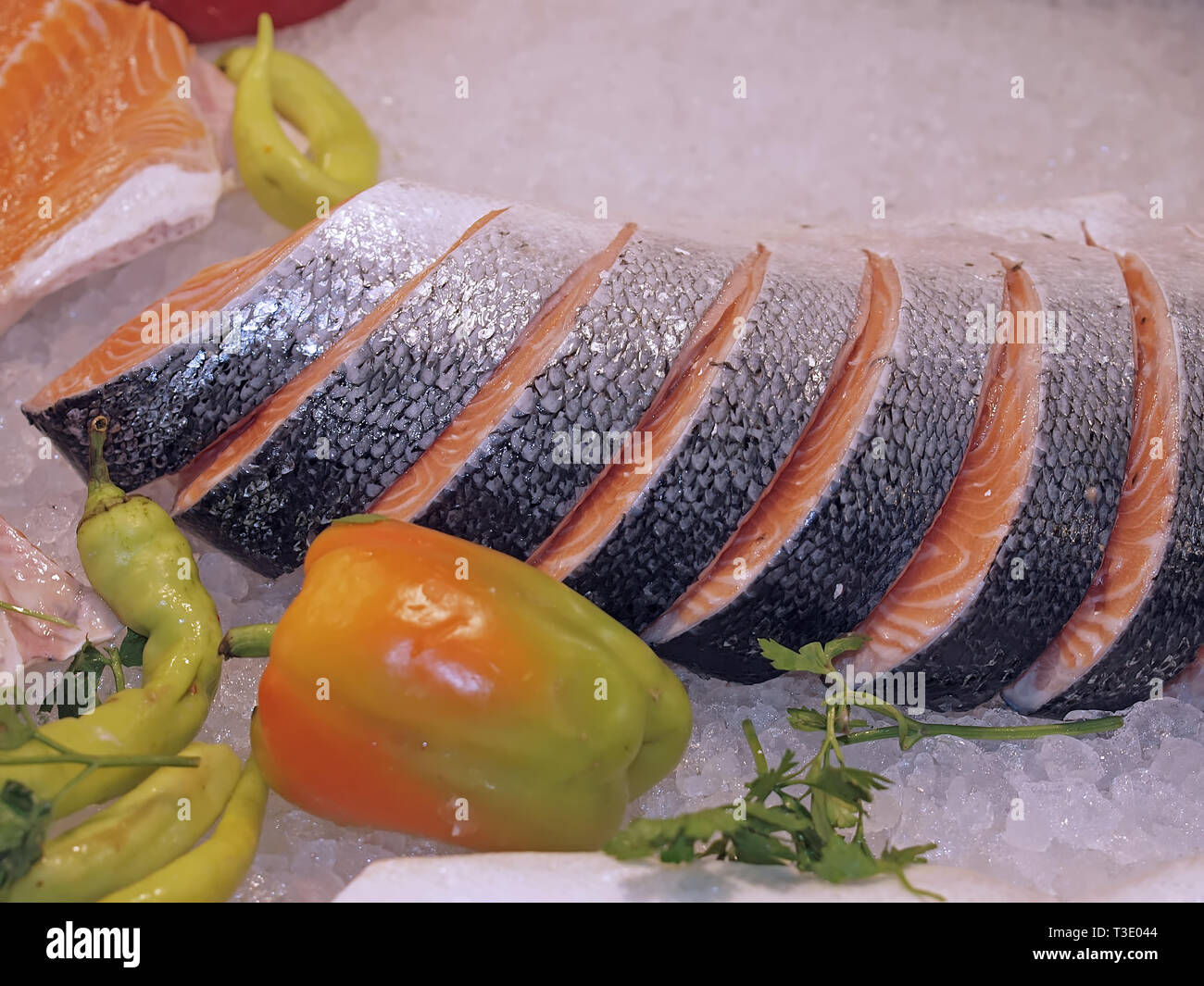 Raw salmon on ice at a fish market with vegetables Stock Photo - Alamy