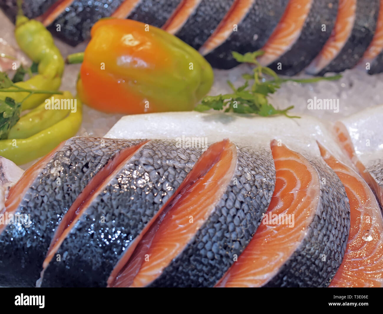 Raw salmon on ice at a fish market with vegetables Stock Photo - Alamy