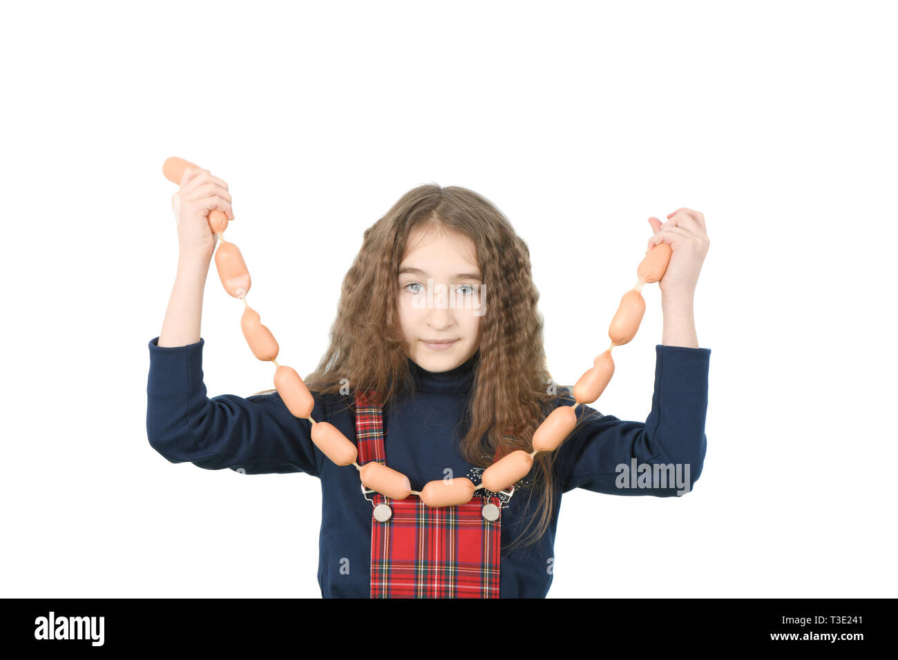 Young girl holds sausages isolated on white. High resolution photo