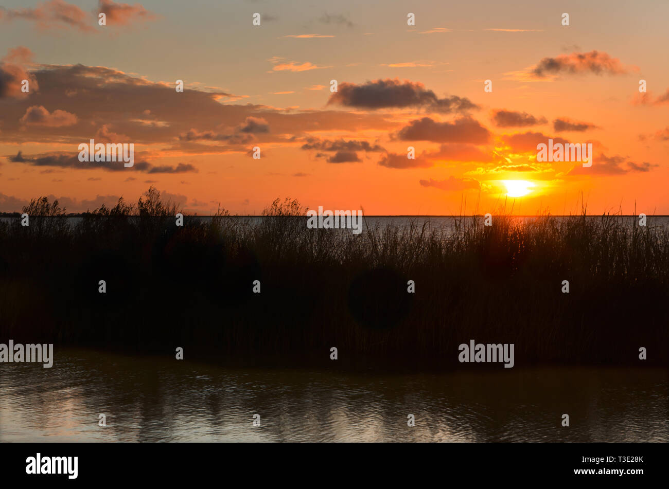 The sun sets over Heron Bay at Cedar Point, Sept. 7, 2012, in Coden, Alabama. Stock Photo