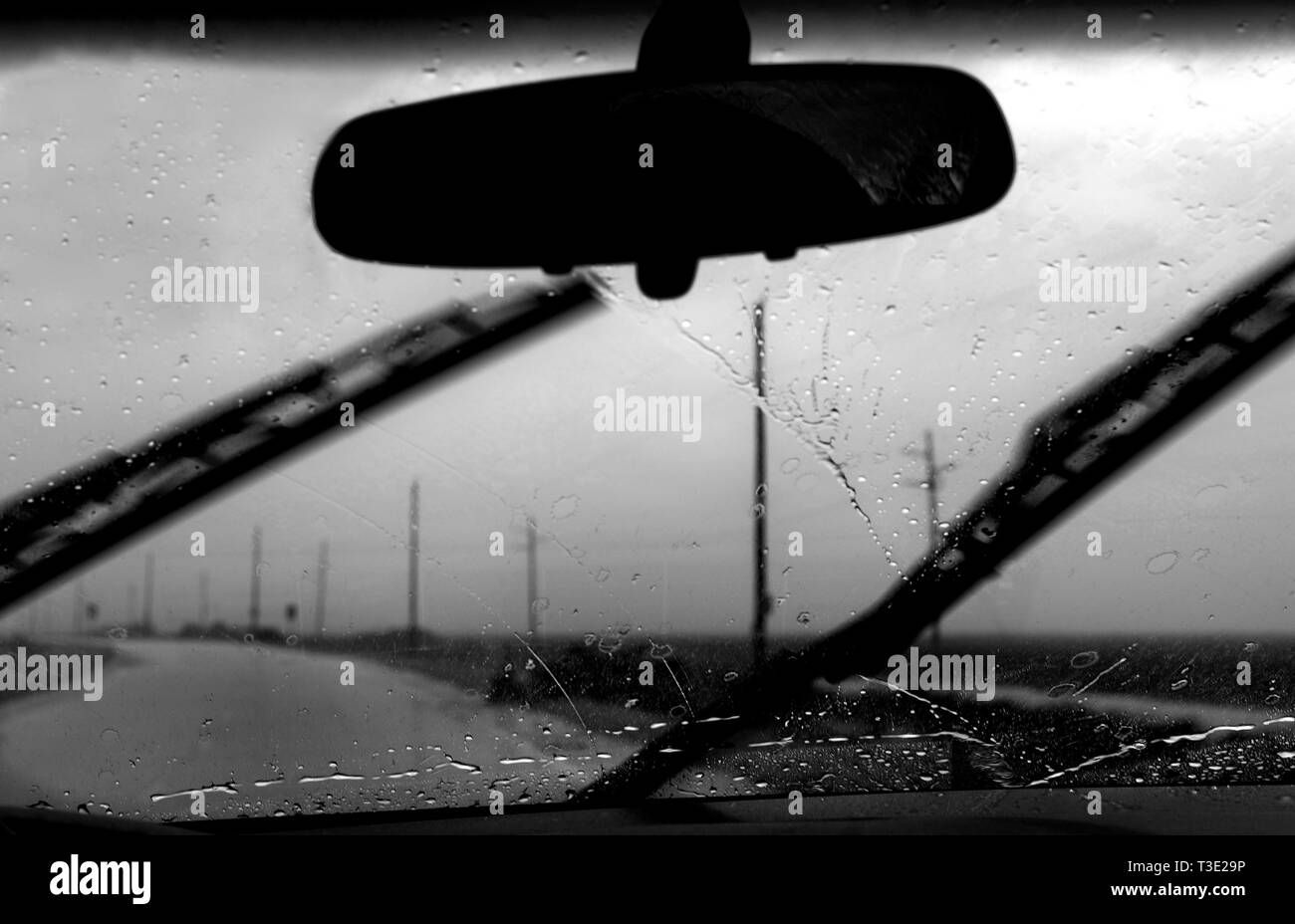 A car drives in the rain as the first feeder bands of Tropical Storm Lee move ashore on Dauphin Island, Alabama Sept. 3, 2011. Stock Photo