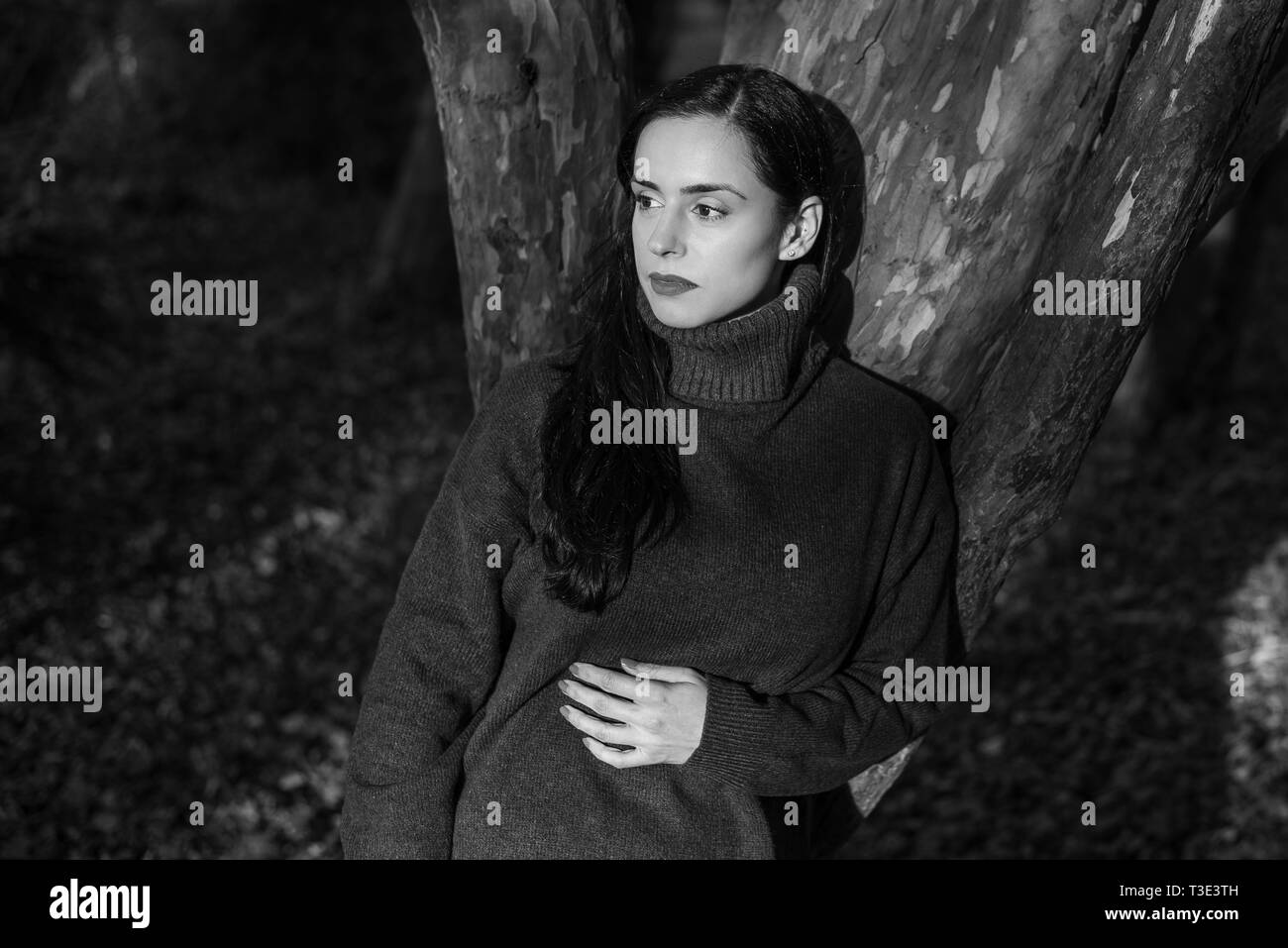 Outdoor Fashion Portrait Of A Black Haired Caucasian Woman Leaning