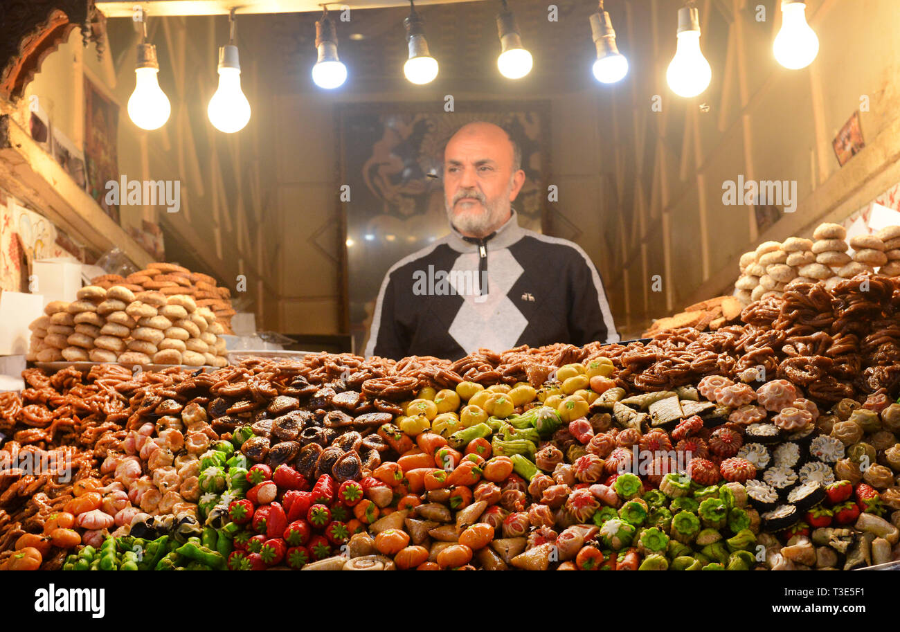 Moroccan sweet shop in the vibrant souk in the medina of Marrakesh. Stock Photo