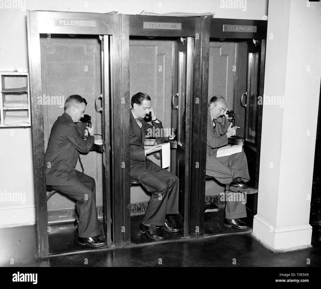 Reporters in White House press room calling in their stories to newspaper editors  ca. 1937 Stock Photo