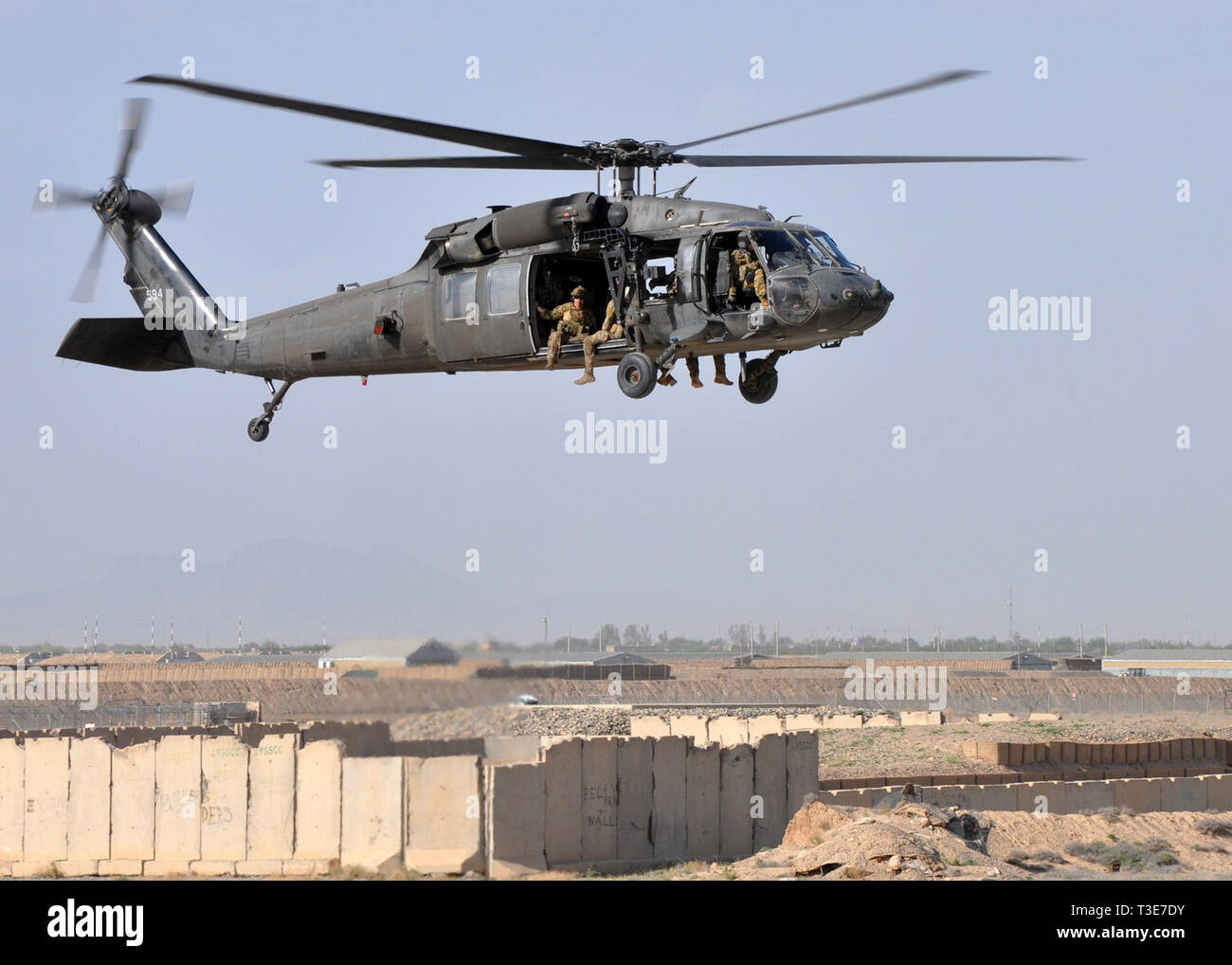 Army National Guardsmen and Air Force pararescuemen from the 64th Expeditionary Rescue Squadron fly in a UH-60 Blackhawk helicopter over Kandahar Airfield, Afghanistan, during joint training April 5, 2019. The rescue Airmen and Soldiers work and train together regularly to be prepared to save lives across the region. (U.S. Air Force photo by Capt. Anna-Marie Wyant) Stock Photo