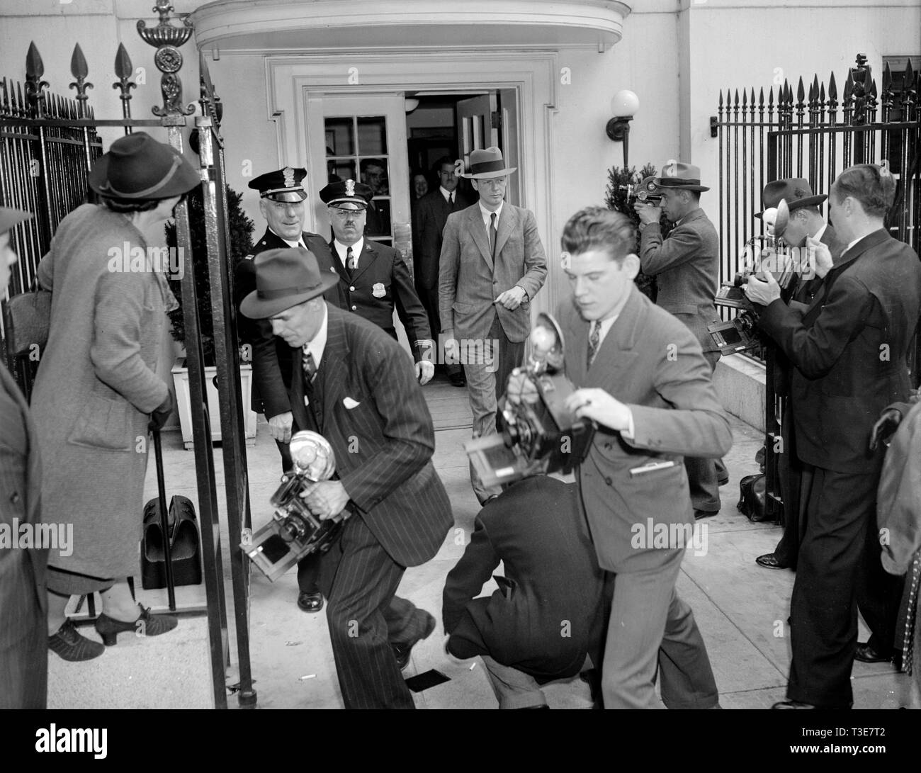 Camera-shy Col. Charles A. Lindbergh leaving the White House walking through Photographer's gauntlet ca. April 20, 1939 Stock Photo