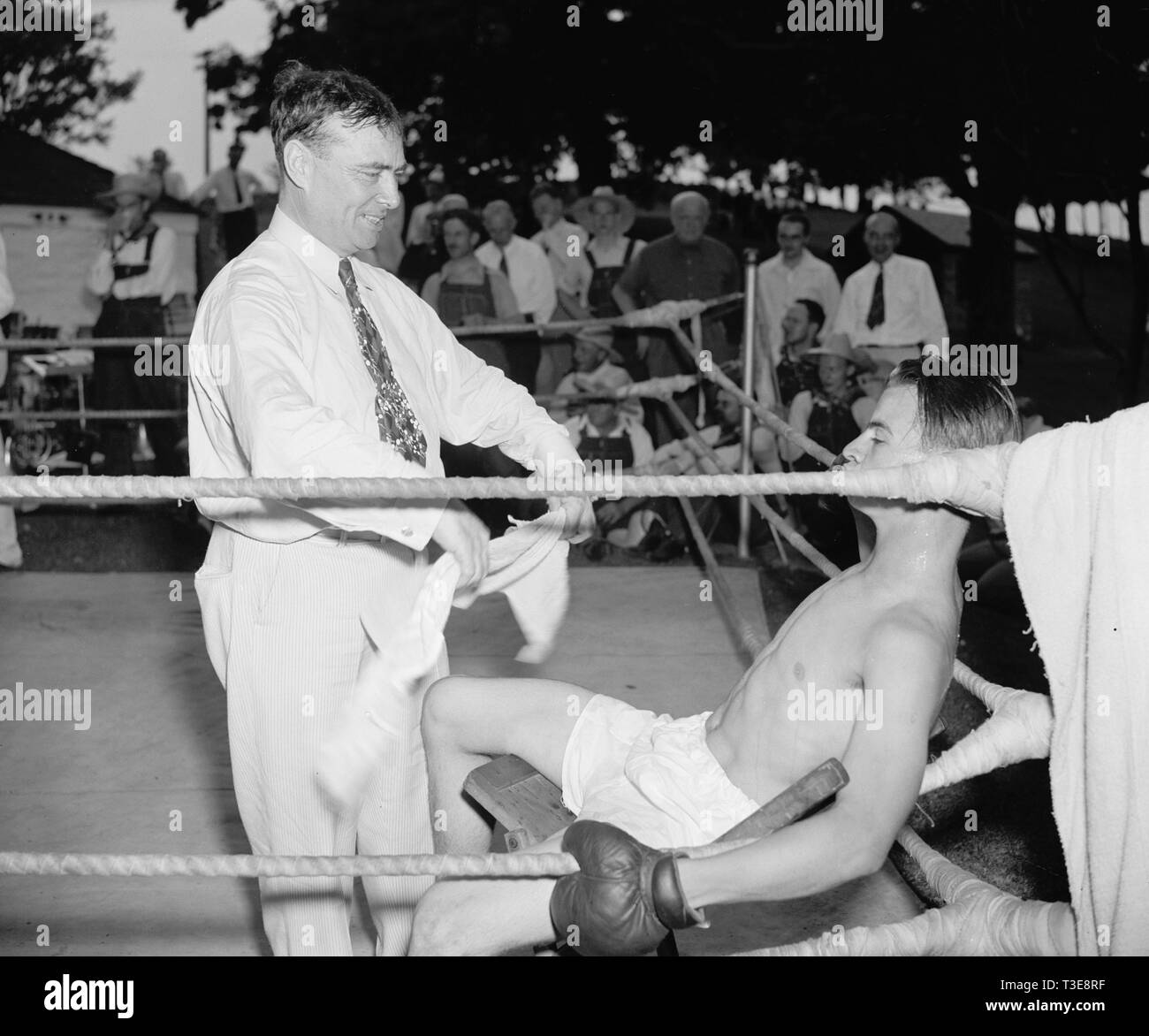 Trainer trying to revive boxer as he rests on his stool between rounds ca. 1937 or 1938 Stock Photo