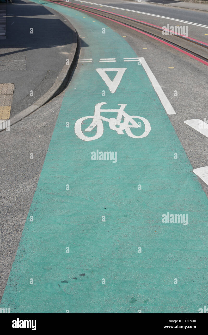 Green painted cycle lane and white cycle symbol on road in Porthmadog