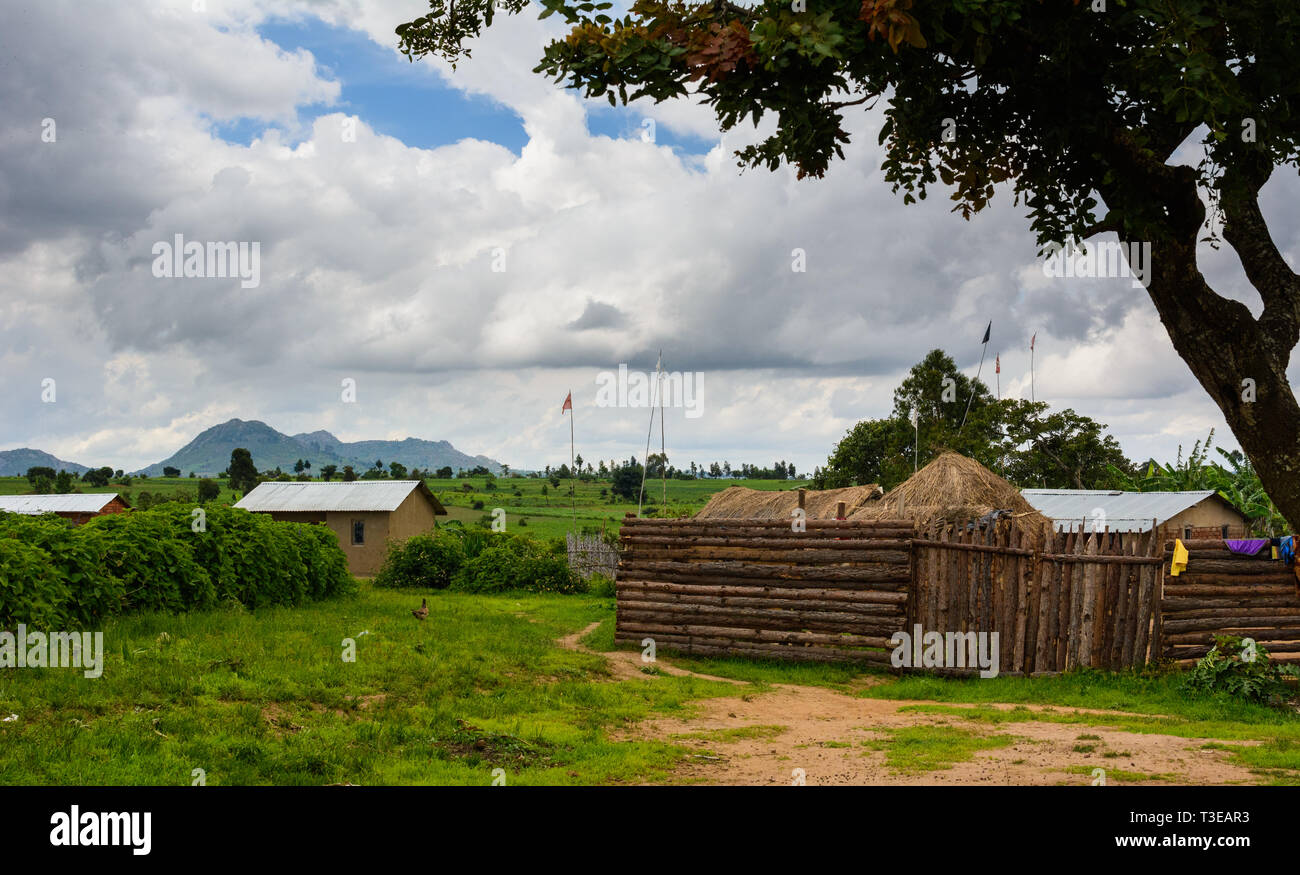 flags flying over a compound in a Malawian village marking that a witchdoctor runs his business at this spot Stock Photo