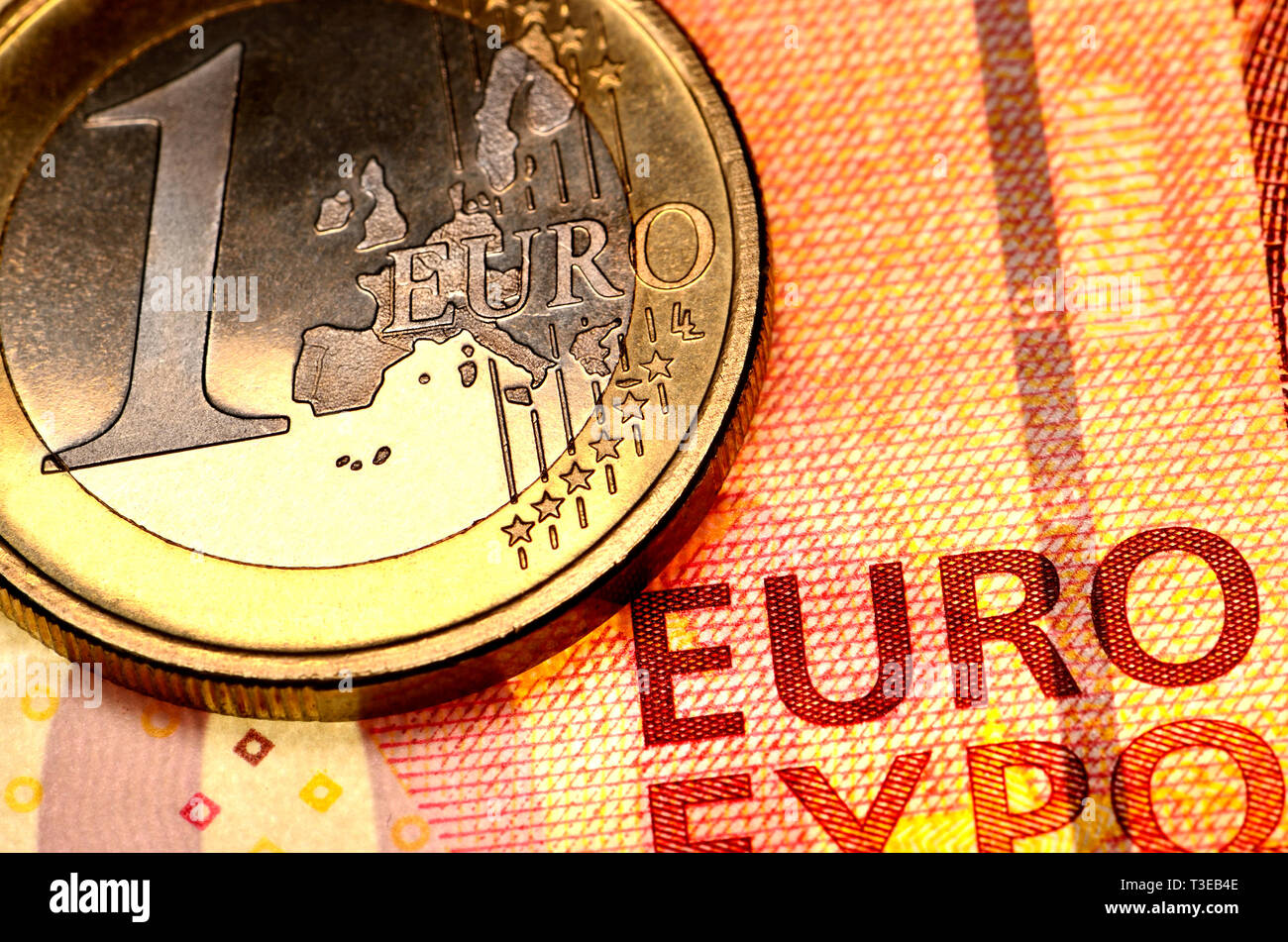 1 Euro coin on a 10 Euro note Stock Photo