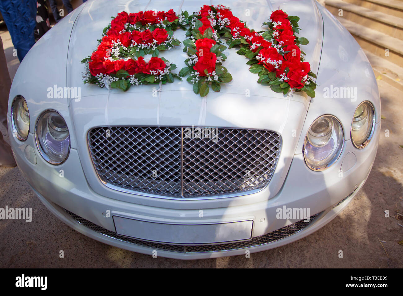 Closeup image of wedding car decoration with red and white flowers ...